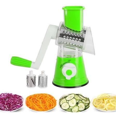 Manual rotary vegetable cutter with three interchangeable stainless steel drum blades for slicing, shredding, and grating vegetables.