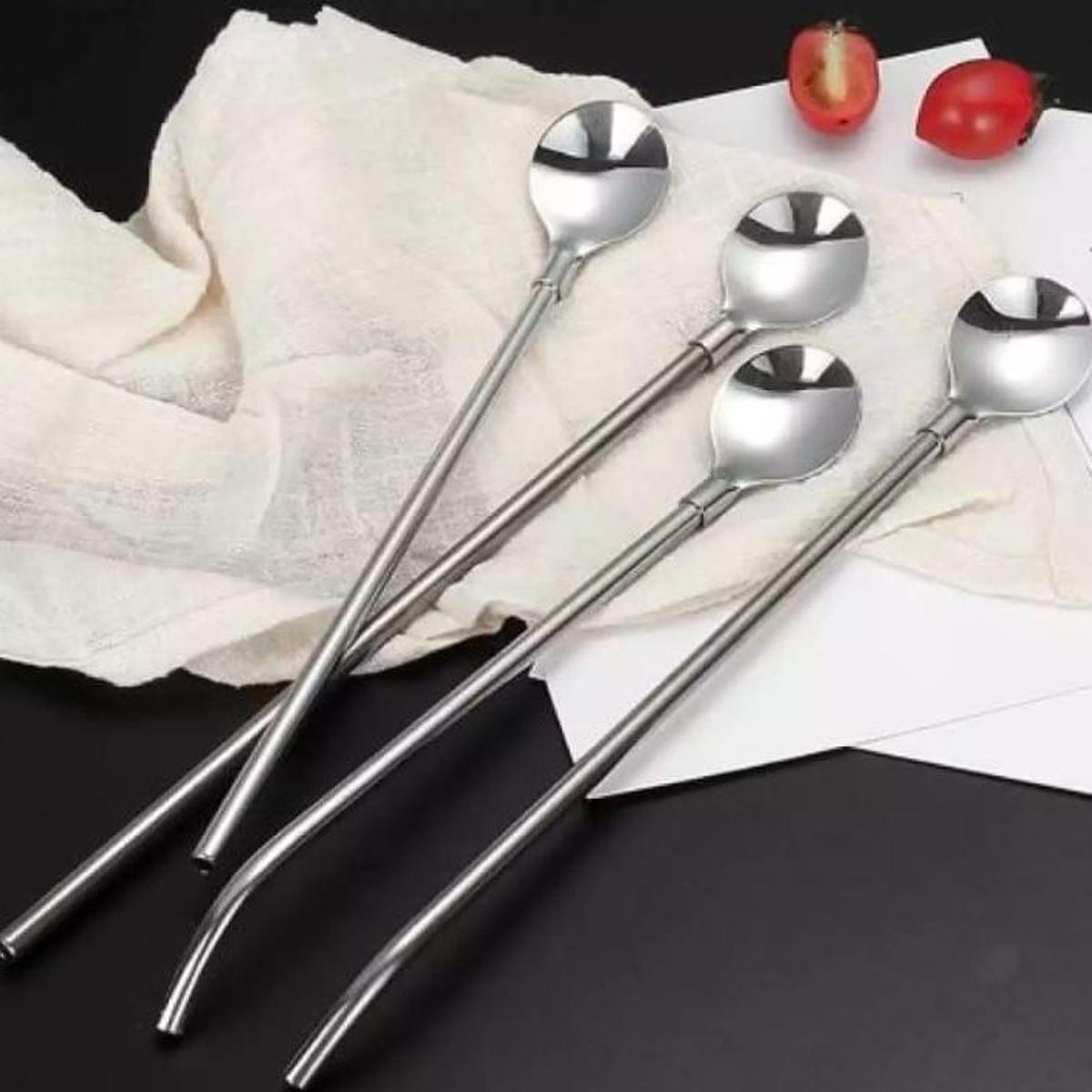 Reusable stainless steel drinking spoon straws on white fabric background