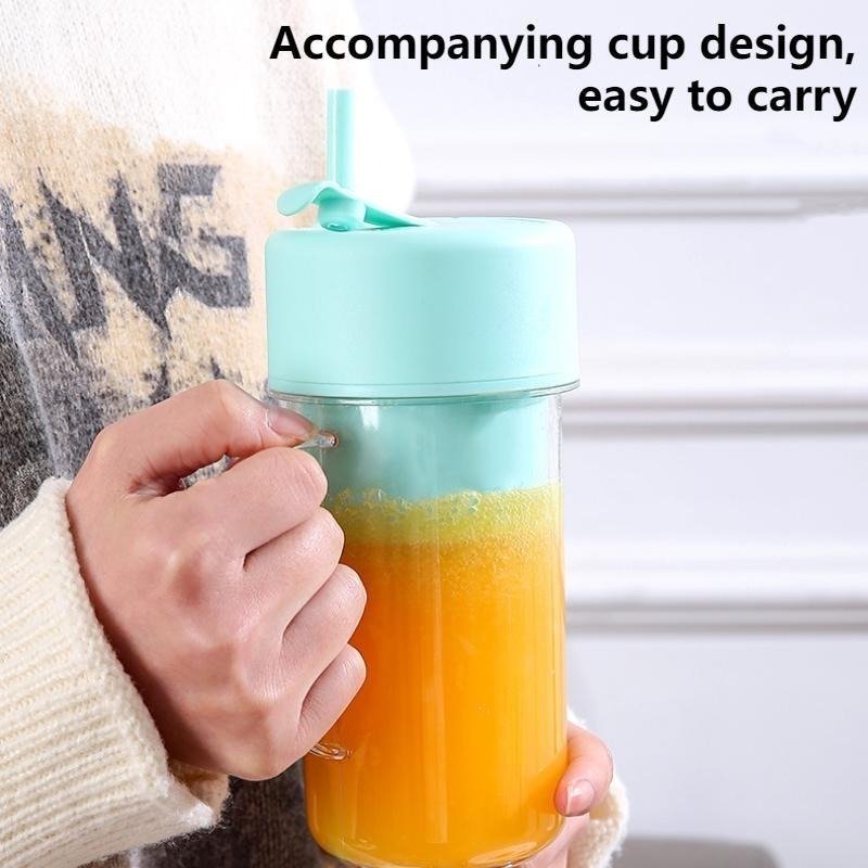 Mint green portable juicer cup with orange juice easy to carry
