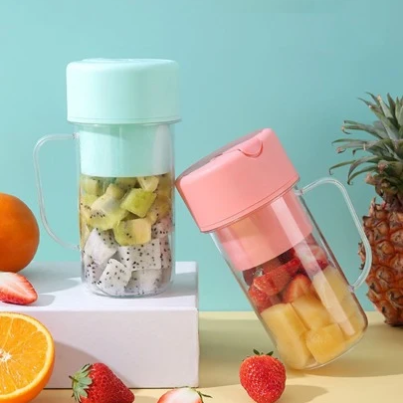 Portable juicer cups filled with kiwi dragon fruit and strawberries