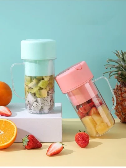Portable juicer cups filled with kiwi dragon fruit and strawberries