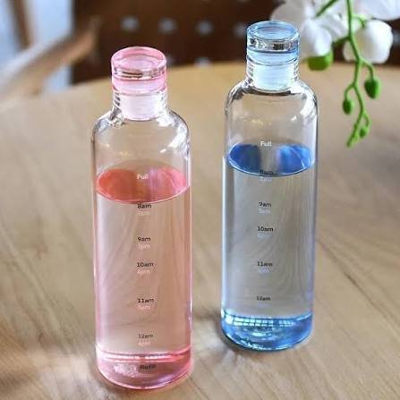 Pink and blue glass hydration bottles with time tracker close-up